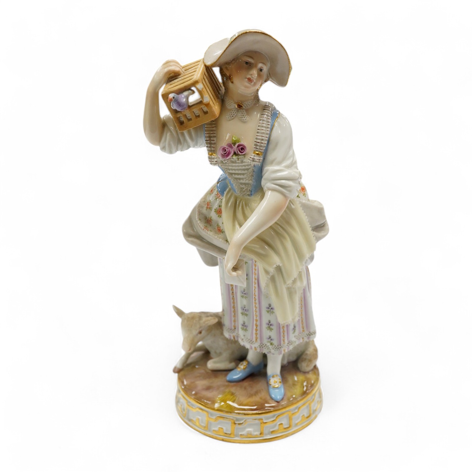 A 19th century Meissen figure of a shepherdess with a birdcage, incised F73, 18cm. Condition - fair